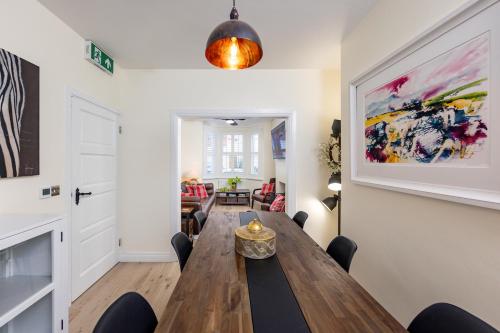 a dining room with a wooden table and chairs at Trevor Street in Holywood