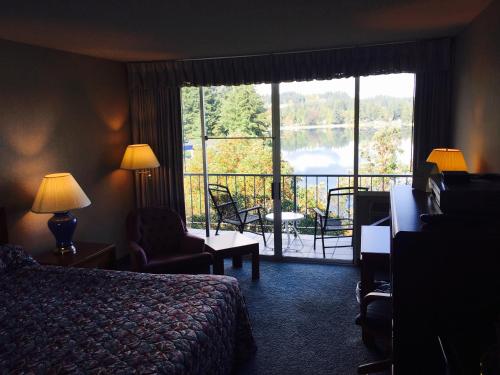 a hotel room with a bed and a large window at Flagship Inn in Bremerton