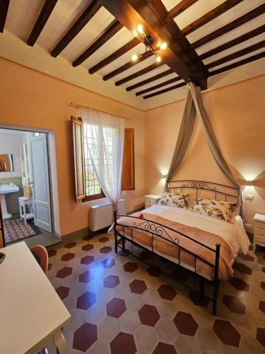 a bedroom with a large bed in a room at Villa Palazzo Delle Erbe in Casole dʼElsa