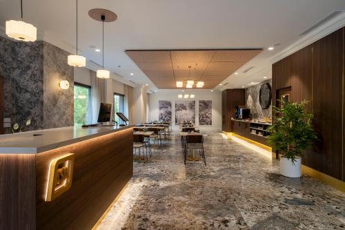 a lobby with a bar with tables and chairs at ASA Molina Plaza in Molina de Segura