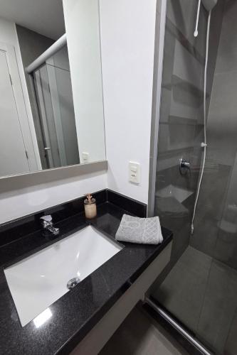 a bathroom with a sink and a shower at LOFT1304 Maxplaza Canoas in Canoas