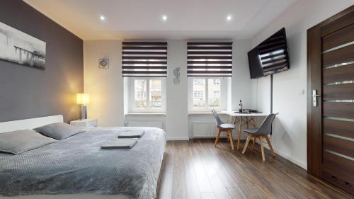 a bedroom with a bed and a table and chairs at Studio Fibra Dolce in Rybnik