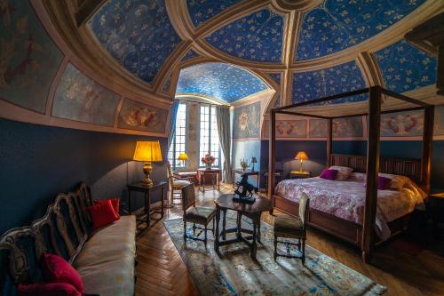 a bedroom with a bed and a ceiling with paintings at Château de la Flocellière in La Flocellière