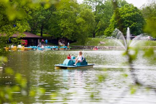 a group of people on a pedal boat in a lake at Oglebay Resort in Wheeling