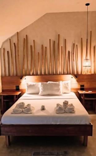 a bedroom with a bed with two pairs of shoes on it at Terra Siargao in General Luna