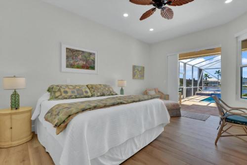 a bedroom with a bed and a ceiling fan at Sunsets At Tiki Terrace in Cape Coral