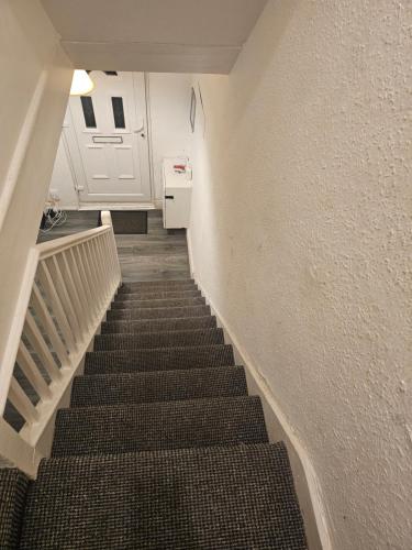 a stairway leading to a room with a white door at Happy Lodge Gillingam Kent in Gillingham