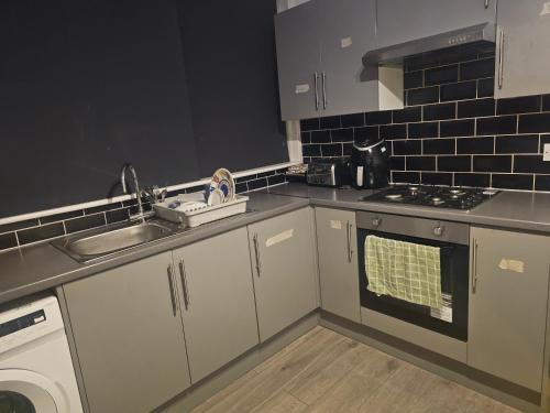 a kitchen with a sink and a dishwasher at Happy Lodge Gillingam Kent in Gillingham