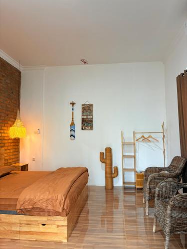 a bedroom with a bed and a ladder and a chair at De Cabin Situjuah in Situjuhbatul