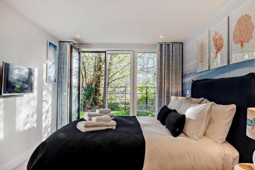 a bedroom with a bed with a large window at 2 Bed in Padstow oc-28108 in Padstow