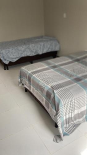 two beds are sitting in a room with at Casa em clube in São José de Ribamar