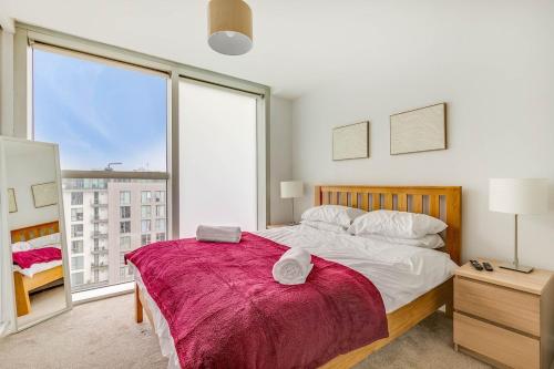 a bedroom with a large bed and a large window at Ruby City Stay Apartment CMK Free Parking in Milton Keynes