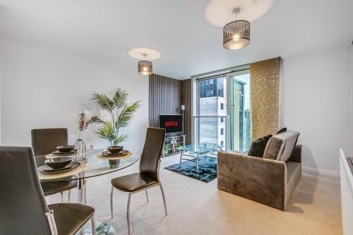 a living room with a dining room table and chairs at Ruby City Stay Apartment CMK Free Parking in Milton Keynes