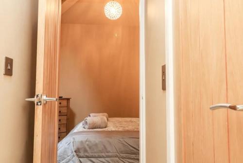 an open door to a bedroom with a bed at 1885 The Retreat in Matlock