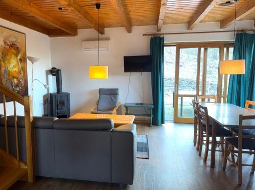 a living room with a couch and a table at Haus 10 Die Kulisse Teutoburger Wald hautnah erleben in Natur Ferienpark in Nieheim