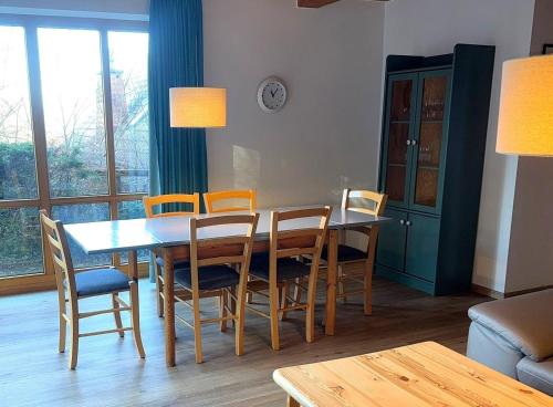 a dining room with a table and chairs at Haus 10 Die Kulisse Teutoburger Wald hautnah erleben in Natur Ferienpark in Nieheim