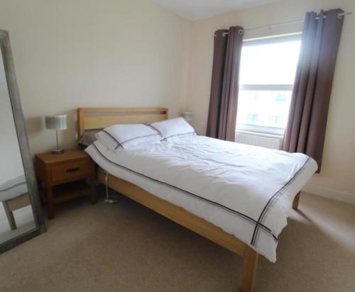 a bedroom with a large bed with a window at Grandholm Crescent in Aberdeen