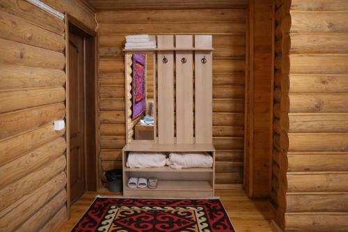 a sauna with a toilet in a wooden room at Мурас Эко - Ресорт in Alamedin