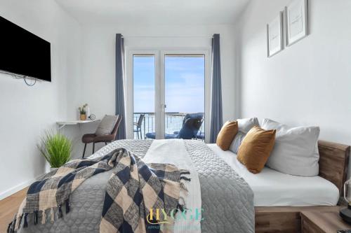 a bedroom with a bed with a view of the ocean at Lodge 18 in Olpenitz