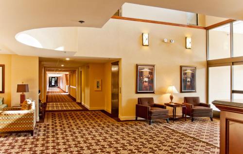 a lobby of a hotel with couches and chairs at Ann Arbor Regent Hotel and Suites in Ann Arbor