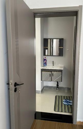 a bathroom with a sink and a mirror at deborahhomes in Marimbeti