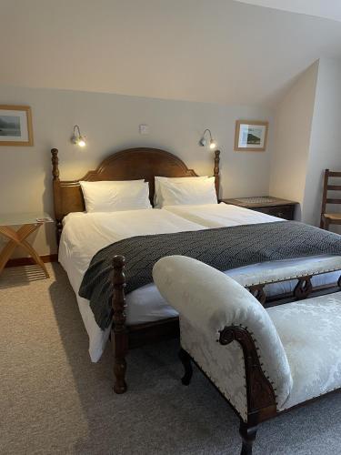 a bedroom with two large beds with white pillows at Craigruie Farmhouse in Balquhidder