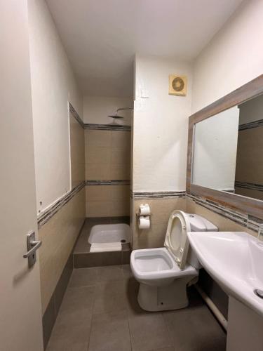 a bathroom with a toilet and a sink at Le Saint Georges Hotel in Port Louis