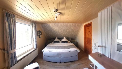 a bedroom with a bed in a small room at Ferienwohnung Lucke in Luftkurort Lückendorf