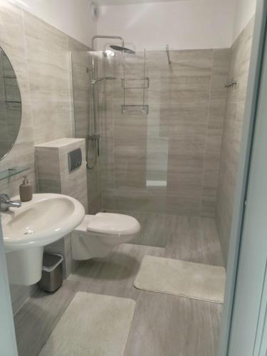 a bathroom with a sink and a toilet and a shower at Przystań Nadole in Nadole