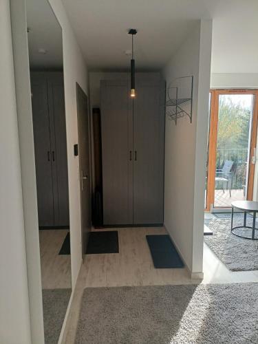 an empty room with a hallway with cabinets and a table at Przystań Nadole in Nadole