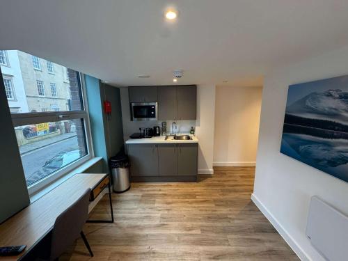 a small kitchen with a sink and a counter at Studio Flat Close to Queen Square - Flat 2B in Bristol