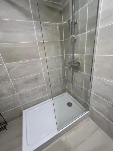 a shower with a glass door in a bathroom at Carriegart in Lurgan
