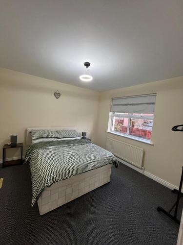 a bedroom with a bed and a window at Carriegart in Lurgan