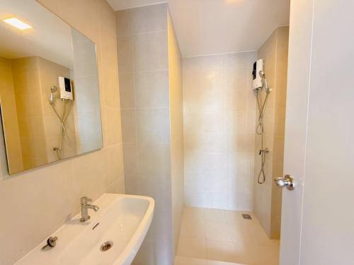 a white bathroom with a sink and a shower at Vay 1 Pattaya Downtown Cozy Condo in North Pattaya