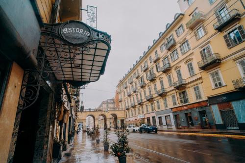 a city street with buildings on a rainy day at Hotel Astoria in Turin