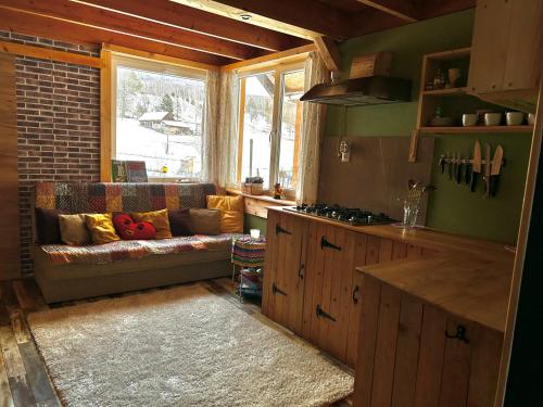 a living room with a couch in a kitchen at Tiny House at Sedliacky Dvor - Brezno in Brezno