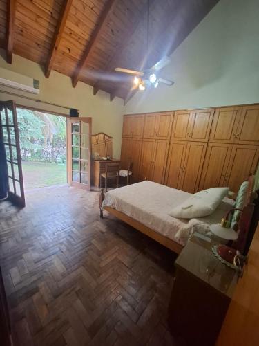 a bedroom with a bed and a large window at Emmac Zen in Ciudad Lujan de Cuyo