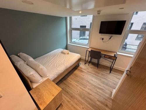 a bedroom with a bed and a desk and a television at Studio Flat Close to Queen Square - Flat 2A in Bristol