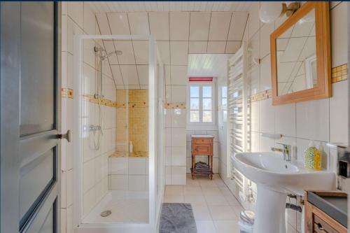 a white bathroom with a sink and a shower at Maison d'hôtes Il était une fois in Pont-lʼÉvêque