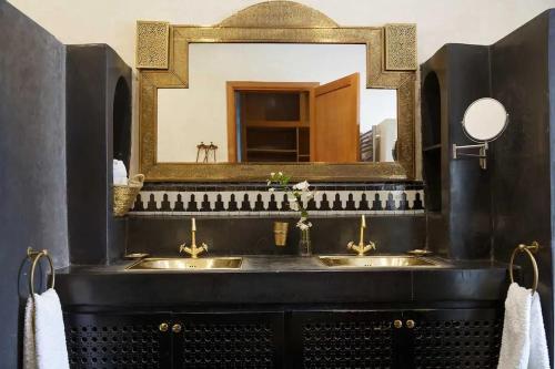 a bathroom with two sinks in front of a mirror at Daba Village in Marrakesh