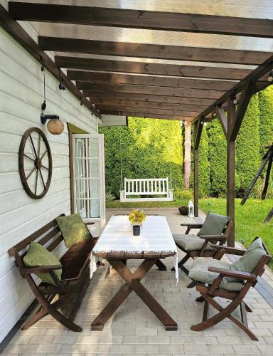 a picnic table and chairs on a patio at Żółte Drzwi Sucha Rzeczka in Sucha Rzeczka