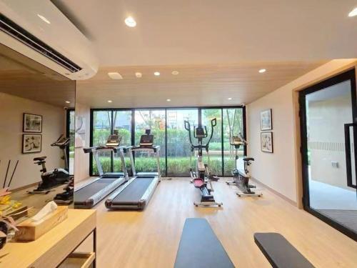 a gym with treadmills and exercise machines in a room at Vay 1 Pattaya Downtown Cozy Condo in North Pattaya