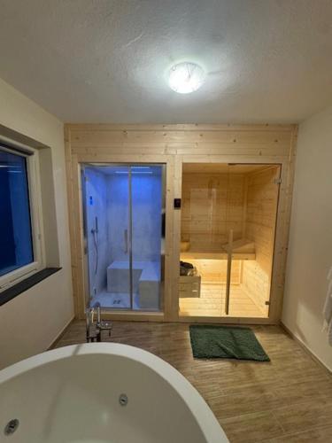 a bathroom with a white tub and a window at Bottega del Sogno in Alice Bel Colle