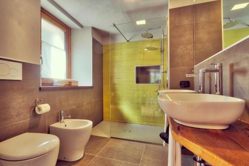 a bathroom with a sink and a toilet at Moncervin in Saint Vincent