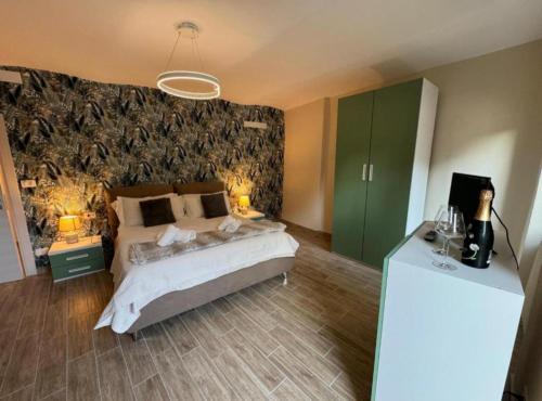 a bedroom with a bed and two tables and two lamps at Bottega del Sogno in Alice Bel Colle