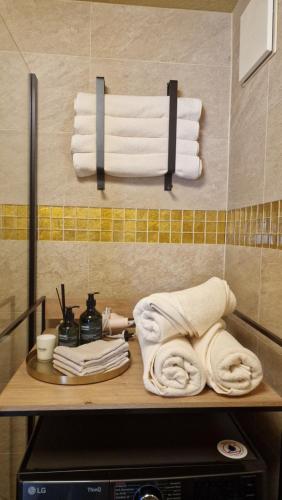 a pile of towels on a shelf in a bathroom at The Boutique Suite - Schaanwald in Schaanwald