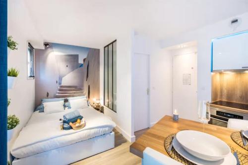 a bedroom with a large white bed and a living room at Night Express - Parking Gratuit Lyon Sud in Saint-Genis-Laval