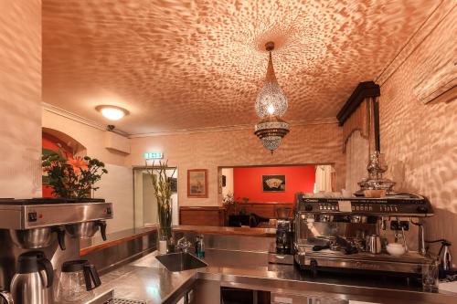 a kitchen with a counter with a stove in it at Hotel Aviv Dresden in Dresden