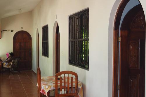 a room with a table and chairs and two doors at Residencial Estephany in Sosúa