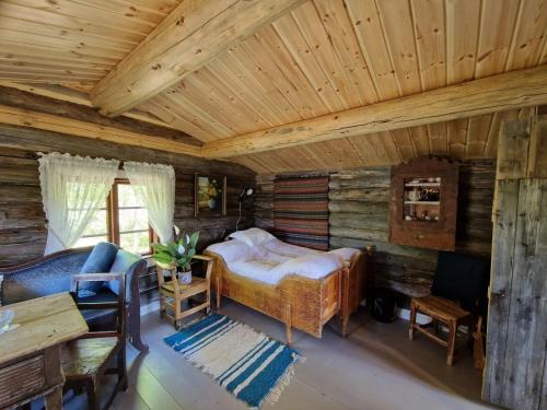 a bedroom with a bed in a log cabin at Smia cabin , A Unique Rustic Hideaway in Lii